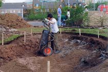 Lining the pond hole with sand