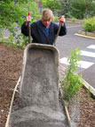 Wheelbarrowing the quarry dust for the path's surface