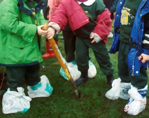 Children in their improvised boots - plastic bags!
